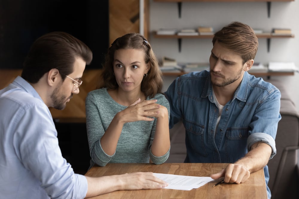 A couple going through a complaints management process with a customer service representative.